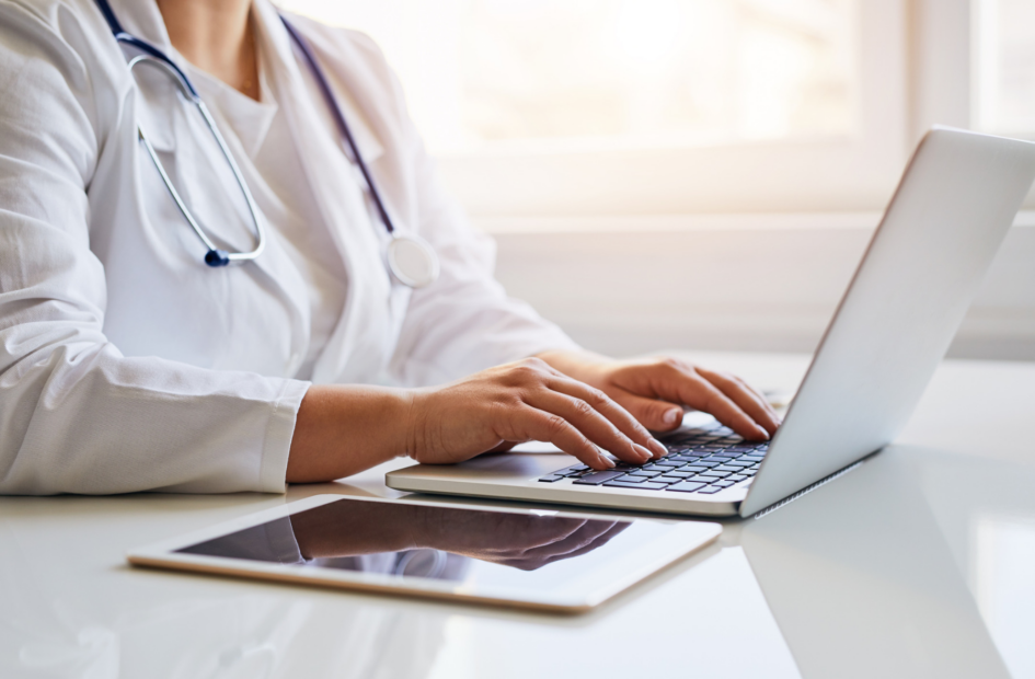 close up of a hospital doctor working on a computer