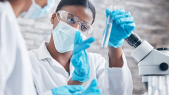 science working with test tubes in a lab