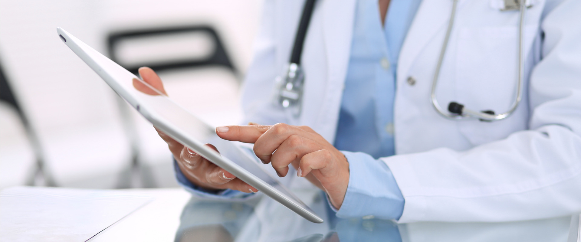physician working on a tablet device