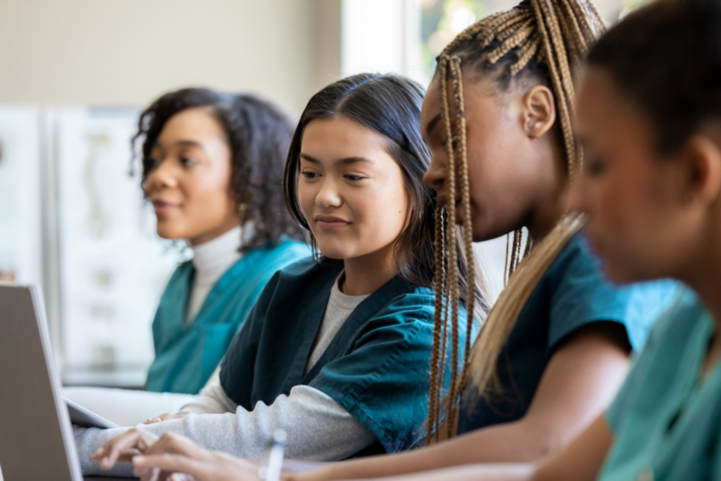 four female healthcare students working in classroom