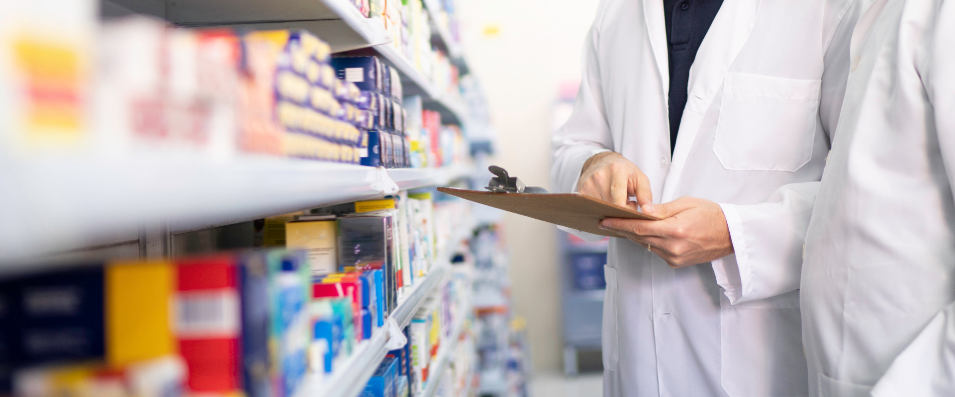 two retail pharmacists following pharmacy policies and procedures