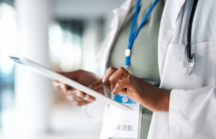 physician working on a tablet device