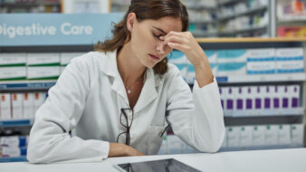 female pharmacist looking stressed